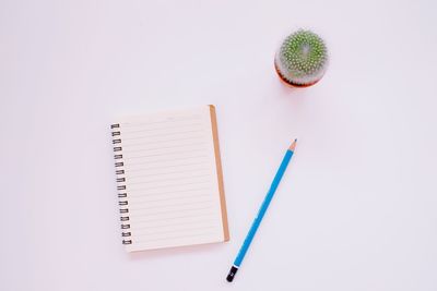 High angle view of pencil on table against white background