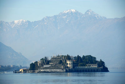 Scenic view of lake by building against sky