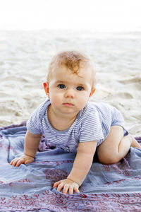 Little baby girl playing with sand at beach. sensory development for kids outdoors.