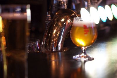 Close-up of beer in glass on counter in bar