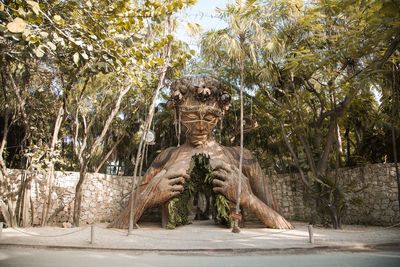 Statue against trees and plants