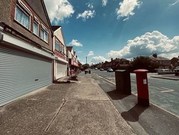 Street amidst buildings against sky