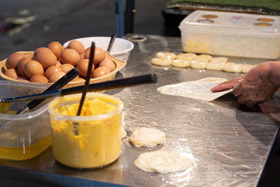 Cropped image of person preparing food in kitchen