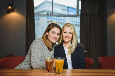 Adult girlfriends resting in bar