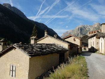 Buildings against sky with mountain in background