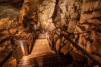 The wooden walking path through stalactite and stalagmite in phu pha petch cave at thailand