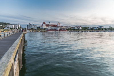 Pier over sea against buildings in city