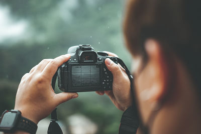 Close-up of hand holding camera