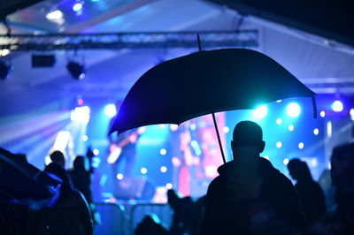 Silhouette people at music concert