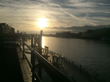 View of city at waterfront during sunset