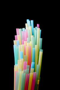 Close-up of colored pencils over black background