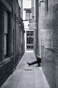 Low section of man amidst buildings at alley in city