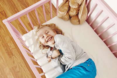 Laughing girl in cot