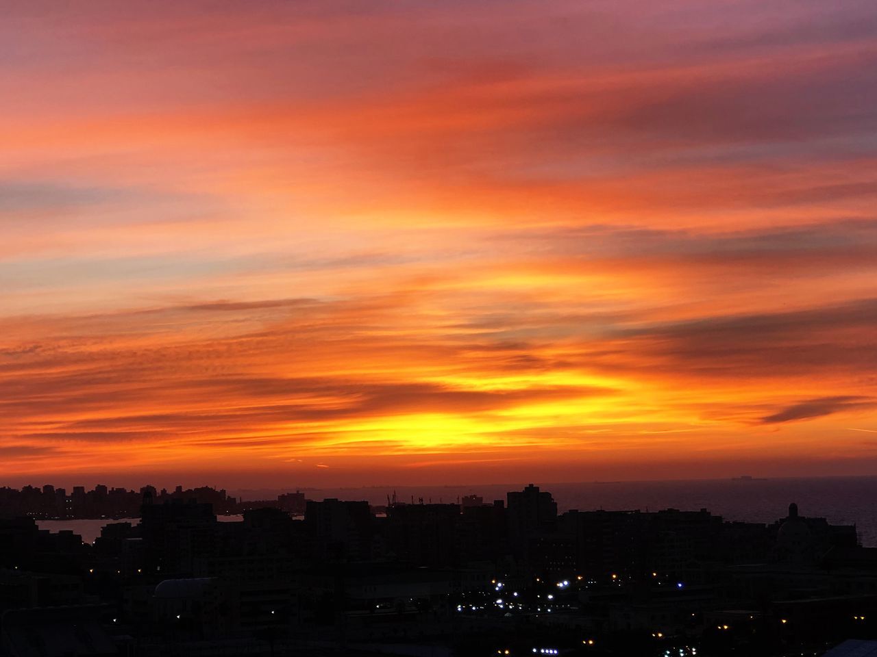 sunset, sky, orange color, architecture, cloud - sky, building exterior, silhouette, built structure, beauty in nature, city, no people, nature, scenics - nature, building, dramatic sky, cityscape, outdoors, idyllic, landscape, residential district, romantic sky