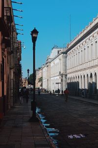 Street amidst buildings in city against sky