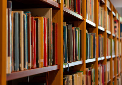 Full frame shot of books arranged on shelf in library