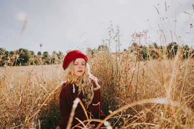 Woman standing on field against sky