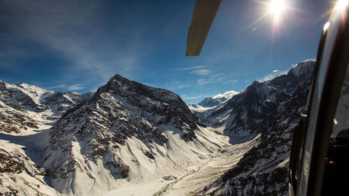 Scenic view of snowcapped mountains against sky during winter