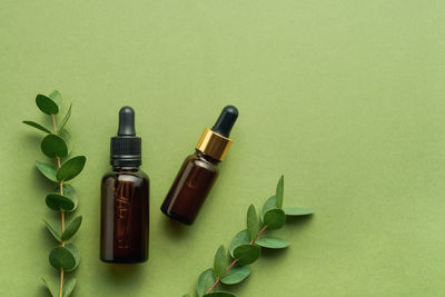 Close-up of bottles against green background