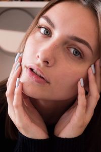 Close-up portrait of young woman using mobile phone