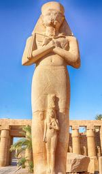 Low angle view of statue against temple