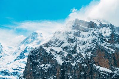 Aerial view of snowcapped mountains against sky