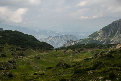 Scenic view of mountains against cloudy sky