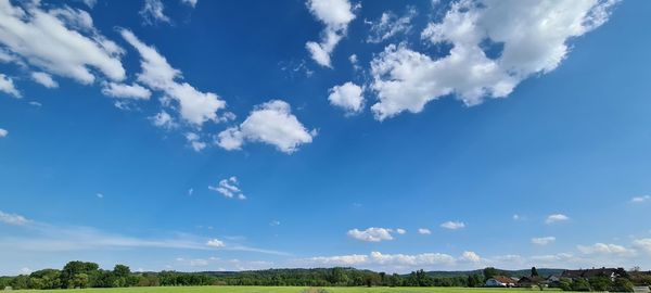 Panoramic view of landscape against blue sky