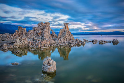 Panoramic view of rock formation in sea against sky