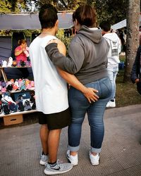 Rear view of people standing on street market