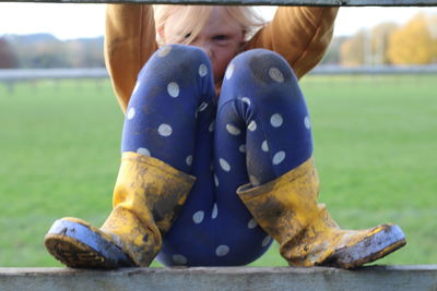 Low section of person sitting on blue chair