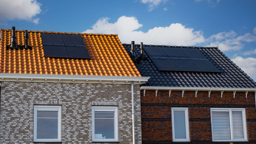 Low angle view of building roof against sky