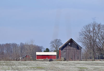 Barn on field against sky