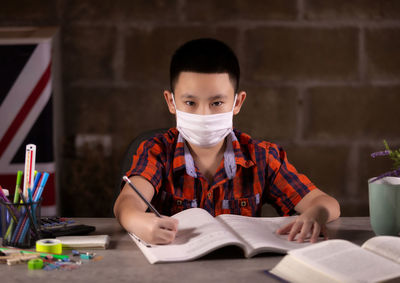 Portrait of boy reading book