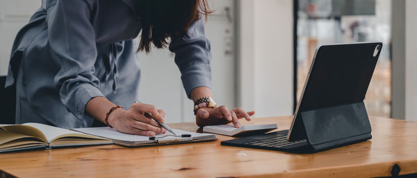 Low angle view of woman working on table