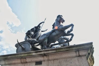 Low angle view of statue against sky