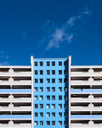 Low angle view of modern building against blue sky