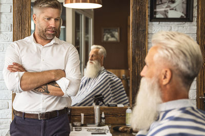 Side view of senior male friends having food at restaurant