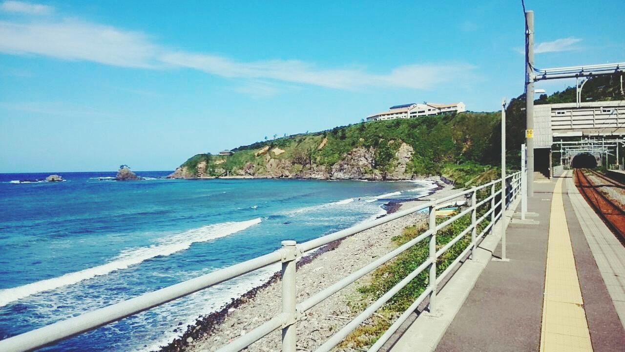 sea, water, sky, transportation, blue, the way forward, horizon over water, beach, built structure, railing, nature, day, incidental people, coastline, scenics, diminishing perspective, beauty in nature, outdoors, architecture, tranquil scene