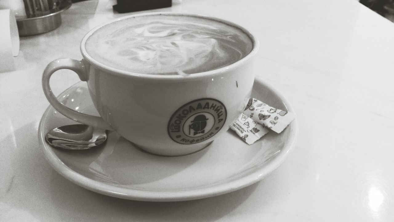 indoors, coffee cup, food and drink, table, drink, still life, saucer, refreshment, coffee - drink, high angle view, freshness, cup, spoon, coffee, close-up, plate, no people, frothy drink, tea cup, directly above