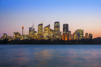 Illuminated city buildings against sky