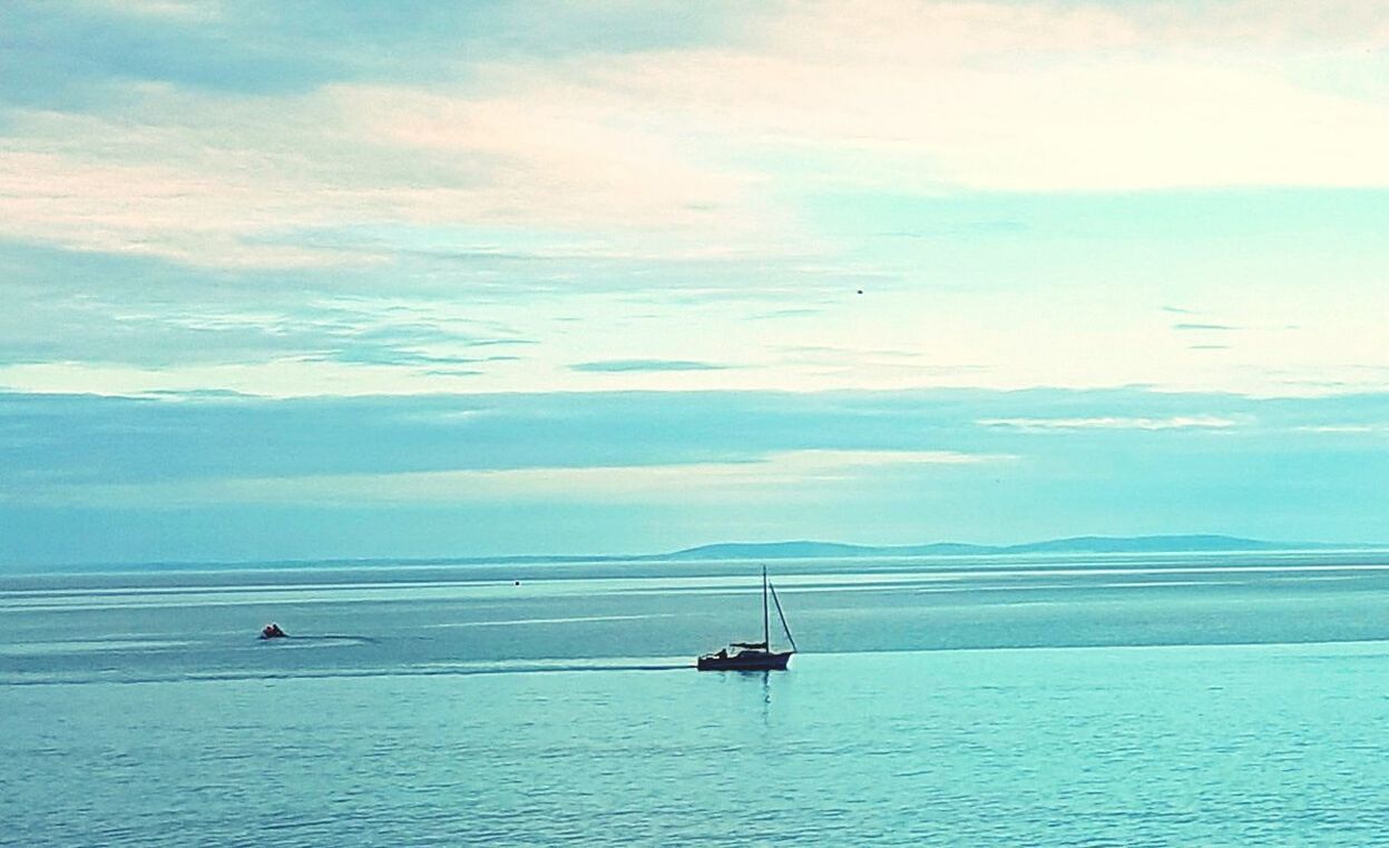 BOAT IN SEA AGAINST SKY