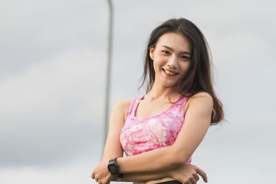 Portrait of a smiling young woman against white background