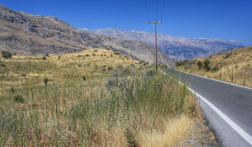 Empty road leading towards mountains