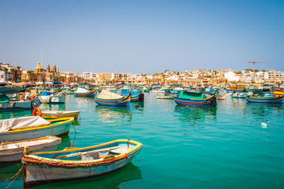 Boats moored at harbor