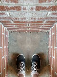 Low section of woman standing on tiled floor