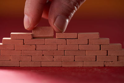 Cropped hand of woman with toy blocks on table