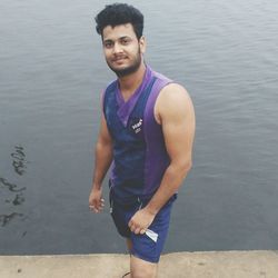 Portrait of young man standing in water