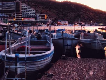 Boats moored at harbor against sky