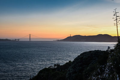 View of suspension bridge at sunset